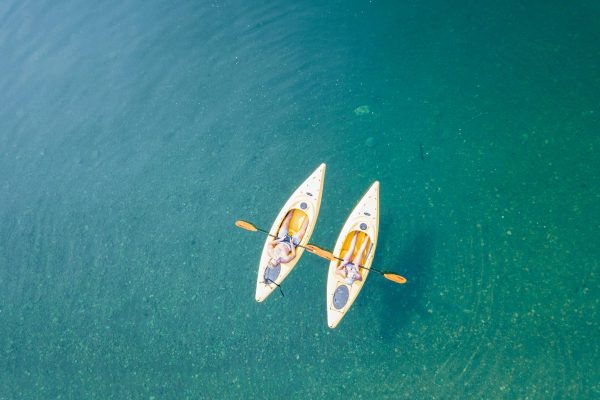 Bird's Eye View of Two People Canoeing on Body of Water